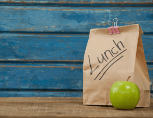 brown paper lunch bag with green apple