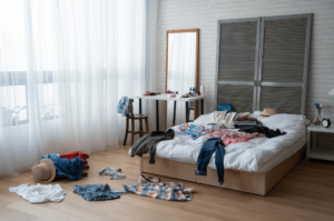 bedroom with clothes all over