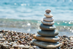 rocks stacked together on pebble beachfront