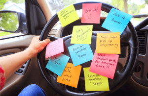 steering wheel of car covered in sticky note reminders