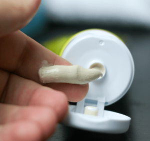 diaper cream being squeezed onto hand