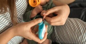 mom clipping baby's finger nails