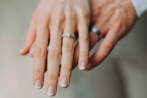 wedding rings on couples hands