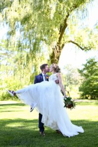 groom holding bride and kissing her