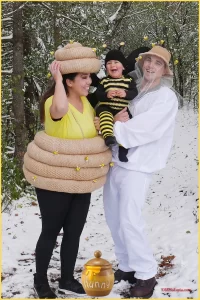 family dressed as beekeeper, bee, and hive for halloween