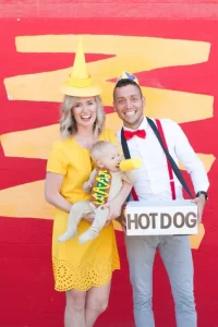 family dressed as hot dog, stand worker, and condiment for halloween