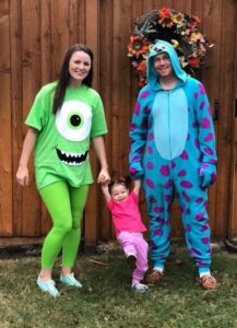 family dressed as mike, sully, and boo from monsters inc for halloween