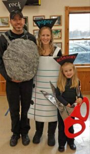 family dressed as rock, paper, and scissors for halloween