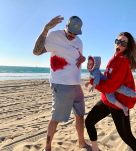 family dressed as lifeguard, shark, and victim for halloween