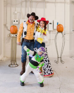 family dressed as woody, jesse, and buzz from toy story for halloween